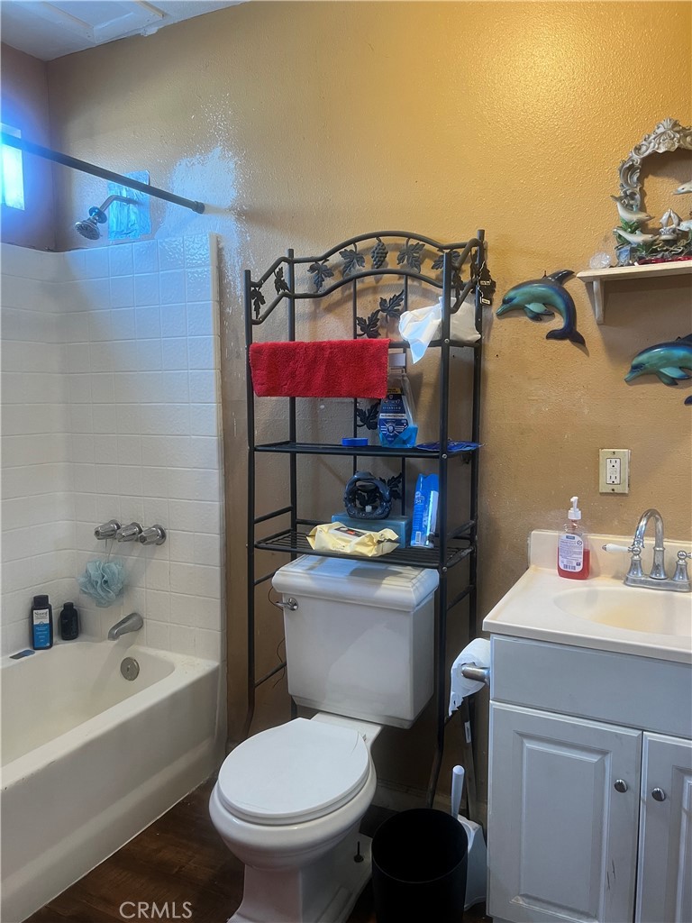 1009 East Stockton Street Compton, CA 90221 - Photo 11 of 14 a bathroom with a toilet a sink and a bathtub