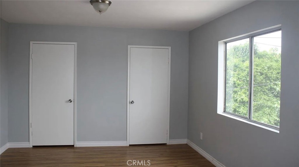 1009 East Stockton Street Compton, CA 90221 - Photo 4 of 14 a view of an empty room with wooden floor and a window