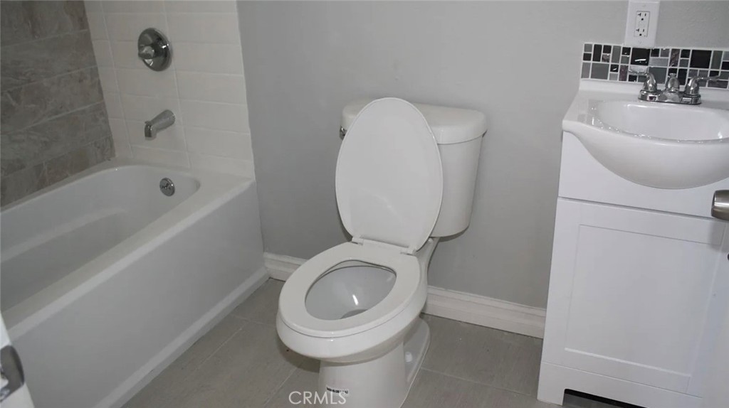 1009 East Stockton Street Compton, CA 90221 - Photo 6 of 14 a bathroom with a toilet sink and mirror
