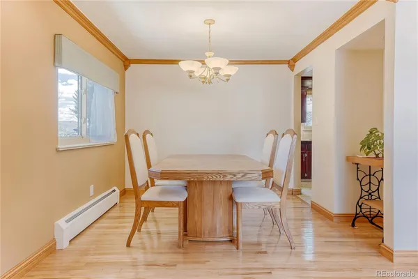 a view of a dining room with furniture and wooden floor