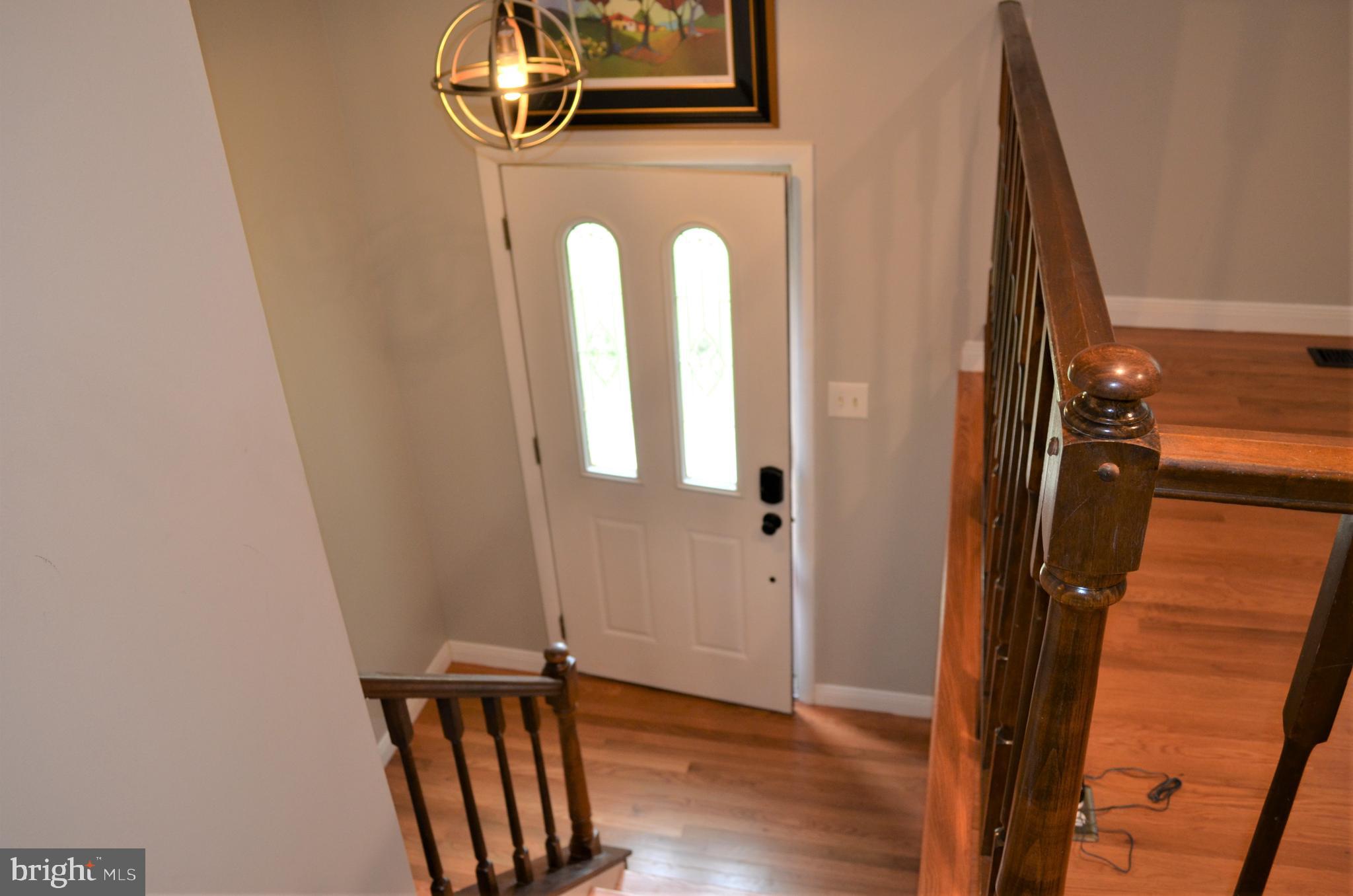 6502 Wrangell Road Bowie, MD 20720 - Photo 3 of 31 Updated lighting & wood floor foyer