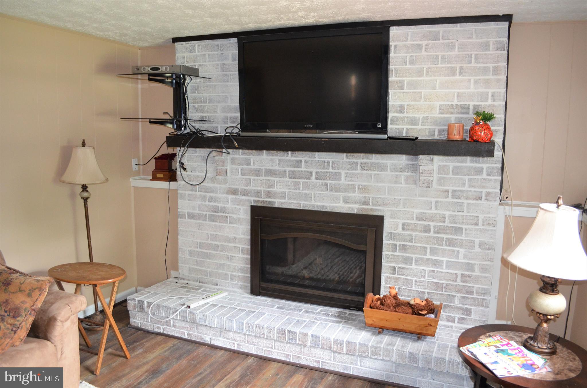 6502 Wrangell Road Bowie, MD 20720 - Photo 23 of 31 White washed gas converted fireplace