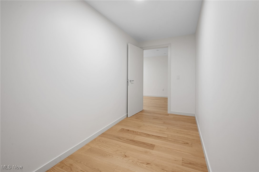 22700 Lake Road, Unit 306 Rocky River, OH 44116 - Photo 23 of 28 Corridor featuring light wood-style floors and baseboards