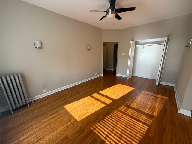 a view of a room with wooden floor and carpet