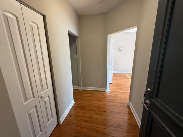 a view of a hallway with wooden floor