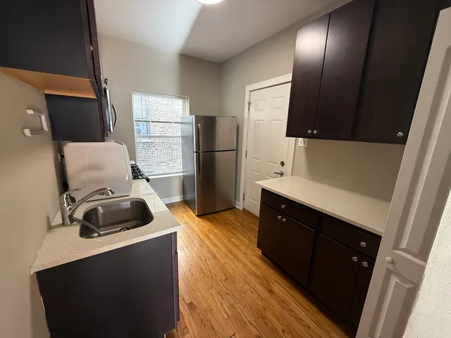 a kitchen with a refrigerator and a stove