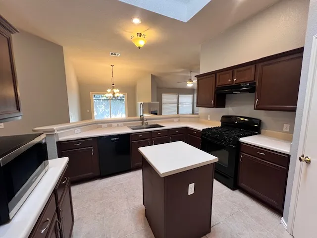 a kitchen with a sink appliances and cabinets