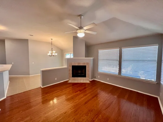a view of a kitchen with a fireplace a sink and wooden floor
