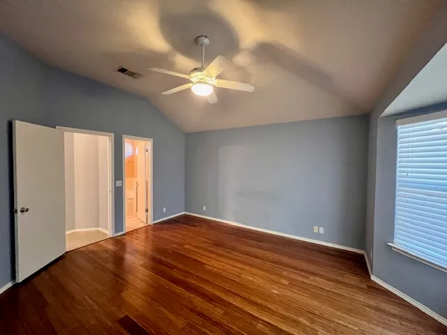 a spacious bathroom with a double vanity sink a mirror and a bathtub