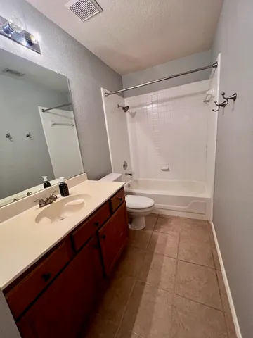 a bathroom with a tub sink toilet and mirror