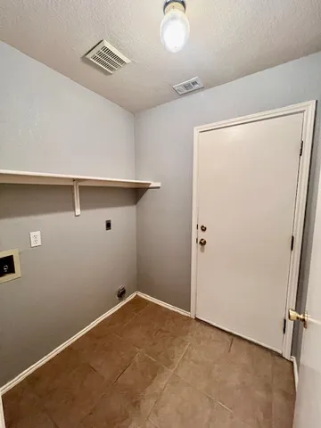 a kitchen with stainless steel appliances kitchen island granite countertop a stove a sink and a refrigerator