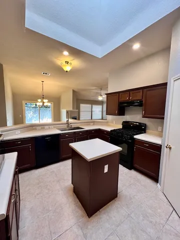 a kitchen with a sink and a stove top oven