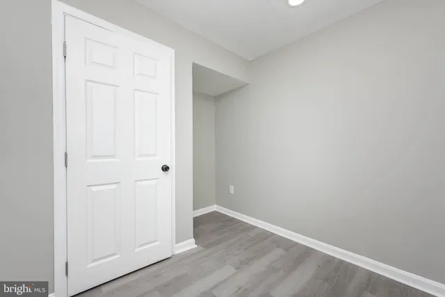 an empty room with wooden floor