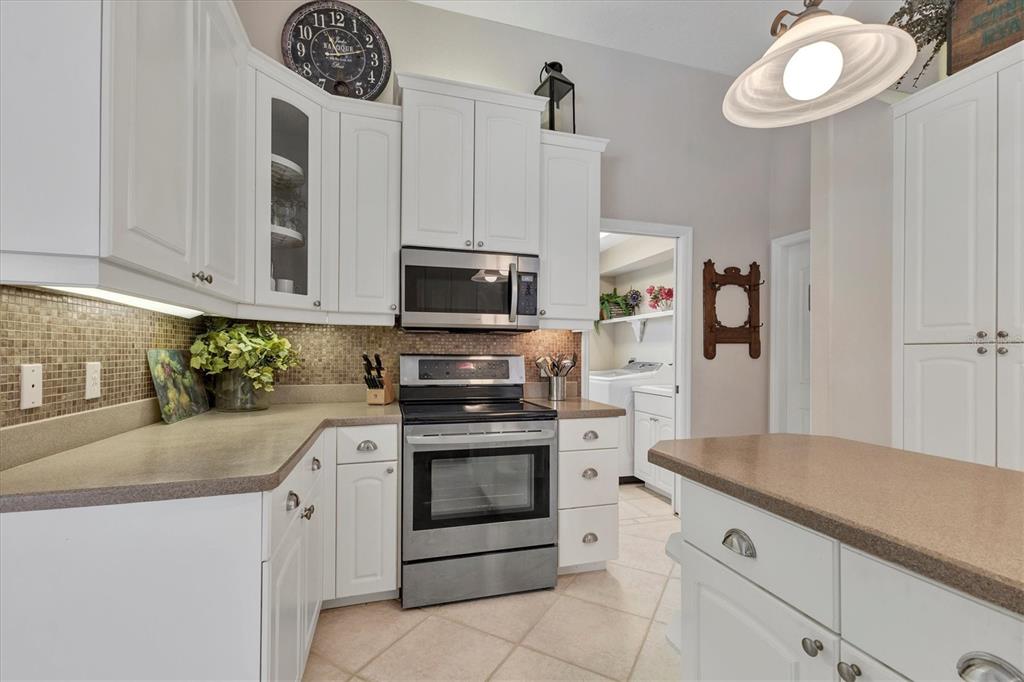 42 Medalist Lane Rotonda West, FL 33947 - Photo 20 of 61 a kitchen with stainless steel appliances white cabinets and a sink