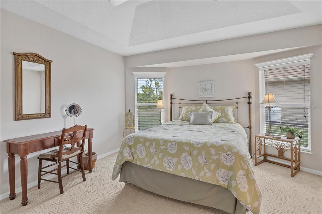 42 Medalist Lane Rotonda West, FL 33947 - Photo 32 of 61 a bedroom with a bed and a lamp on table