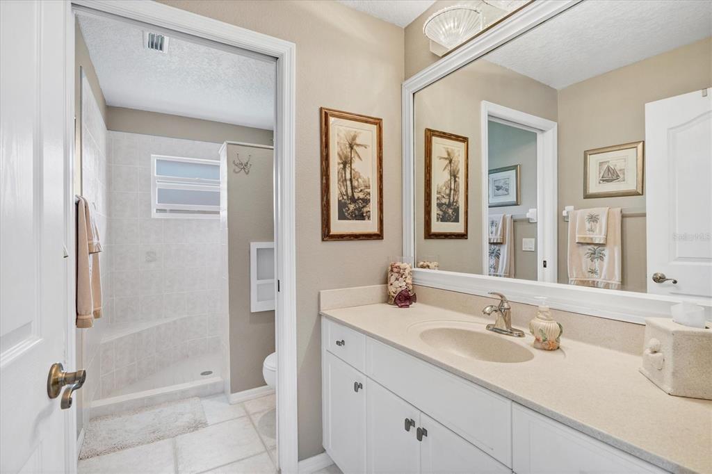 42 Medalist Lane Rotonda West, FL 33947 - Photo 33 of 61 a bathroom with a double vanity sink a toilet a shower and a mirror