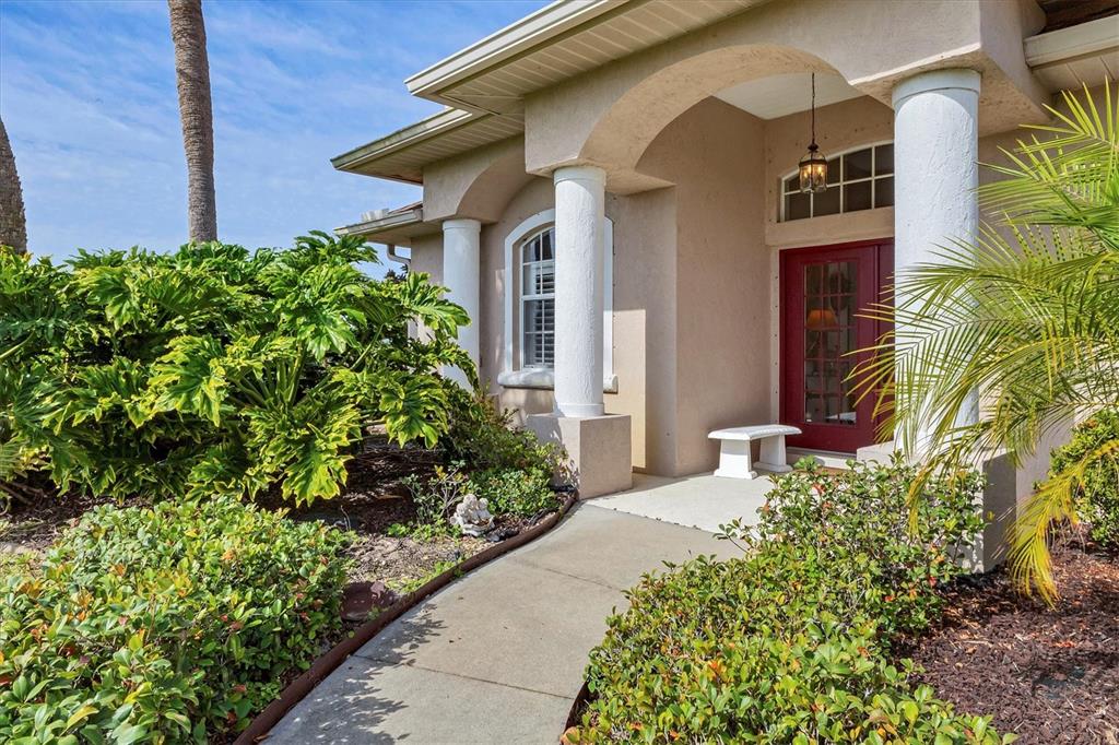 42 Medalist Lane Rotonda West, FL 33947 - Photo 7 of 61 a front view of a house with a yard