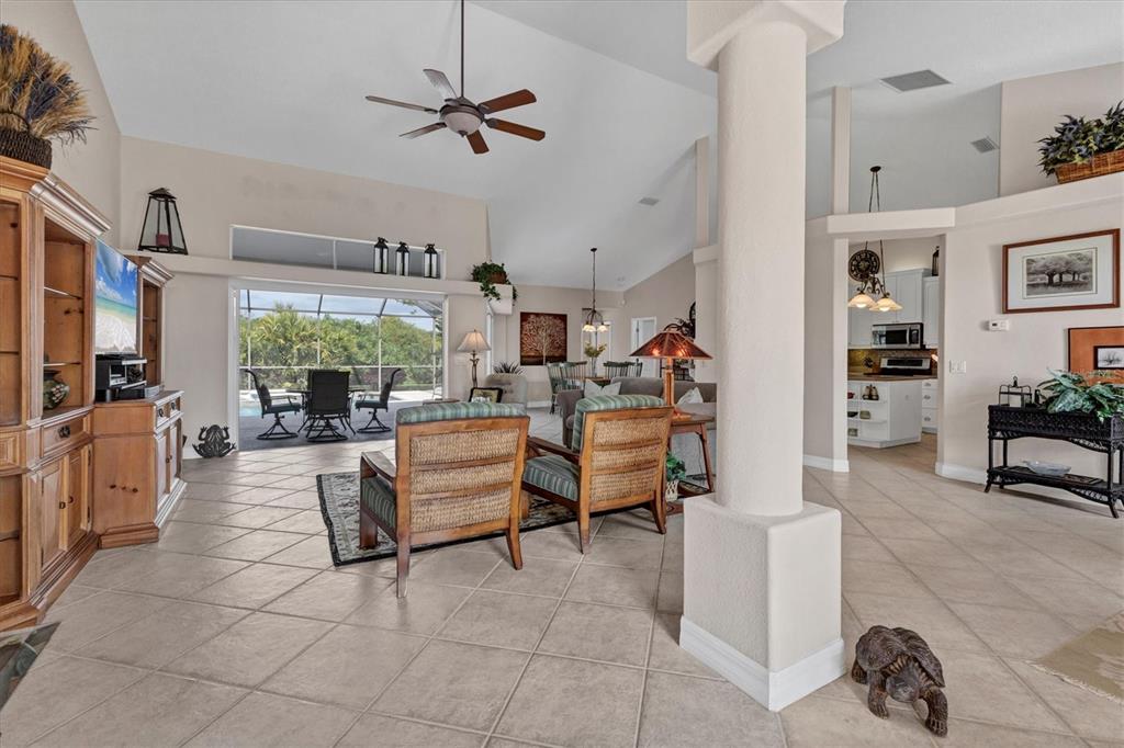 42 Medalist Lane Rotonda West, FL 33947 - Photo 9 of 61 a living room with furniture and a large window