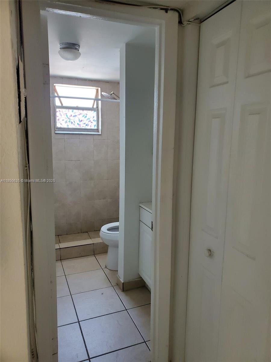 1100 Northeast 1st Court, Unit 106 Hallandale Beach, FL 33009 - Photo 12 of 16 a bathroom with a toilet