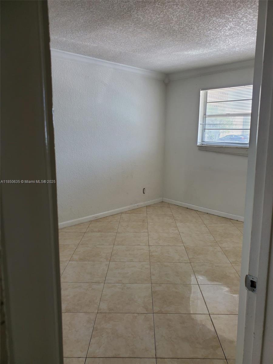 1100 Northeast 1st Court, Unit 106 Hallandale Beach, FL 33009 - Photo 9 of 16 a view of an empty room