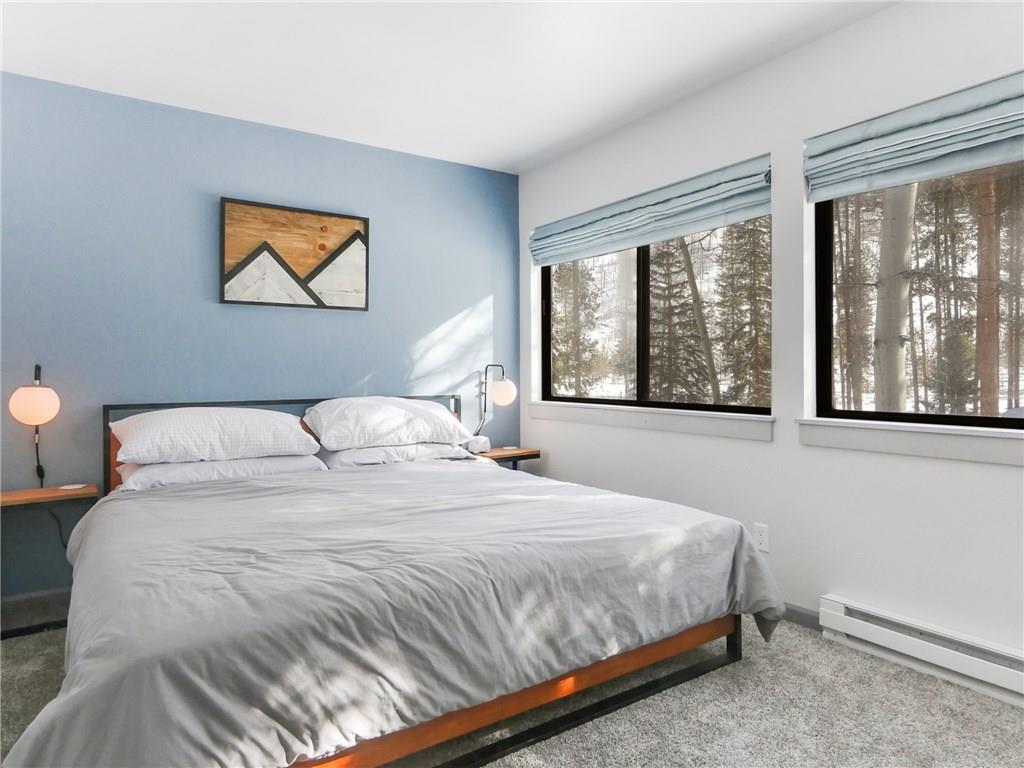 1928 Soda Ridge Road, Unit 1225 Keystone, CO 80435 - Photo 21 of 33 a bedroom with a bed and a large window