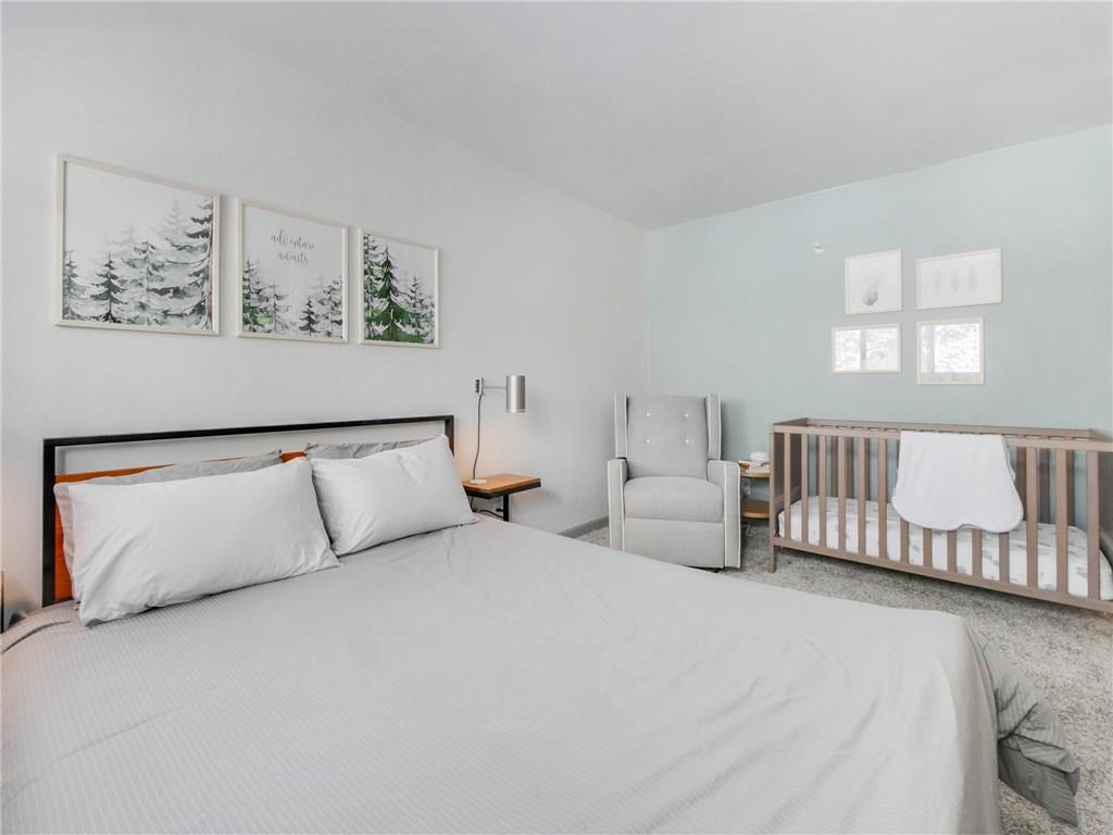 1928 Soda Ridge Road, Unit 1225 Keystone, CO 80435 - Photo 27 of 33 a bedroom with a large bed and a couch