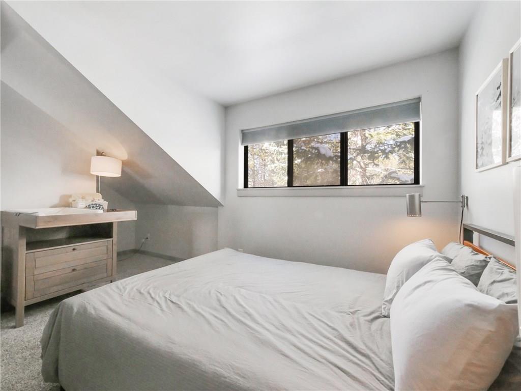 1928 Soda Ridge Road, Unit 1225 Keystone, CO 80435 - Photo 29 of 33 a bedroom with a bed and a window
