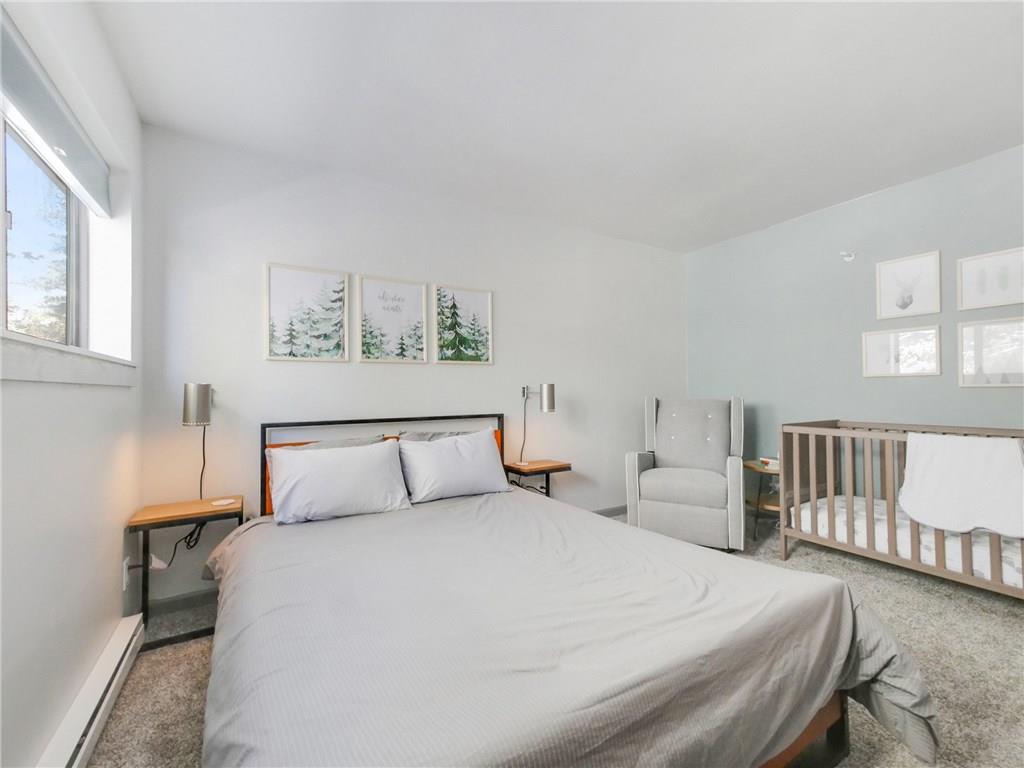 1928 Soda Ridge Road, Unit 1225 Keystone, CO 80435 - Photo 30 of 33 a bedroom with a large bed and a table