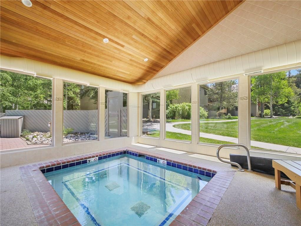 1928 Soda Ridge Road, Unit 1225 Keystone, CO 80435 - Photo 31 of 33 a swimming pool with outdoor seating and yard