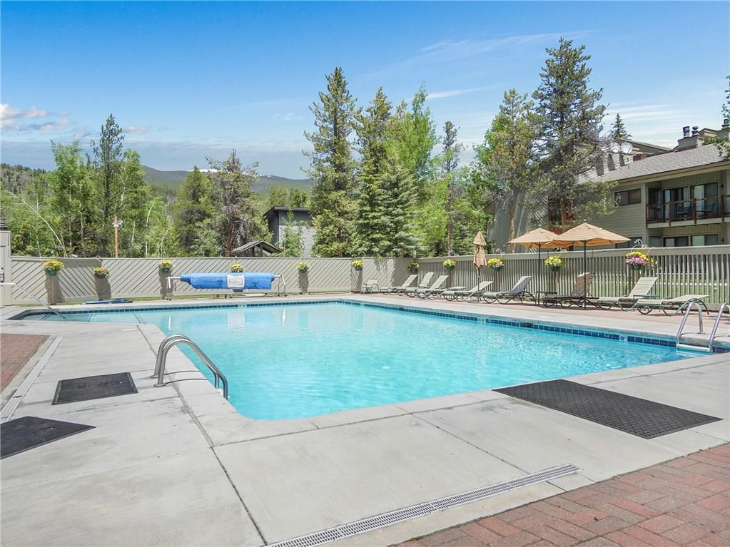 1928 Soda Ridge Road, Unit 1225 Keystone, CO 80435 - Photo 33 of 33 a view of swimming pool with outdoor seating and trees in the background