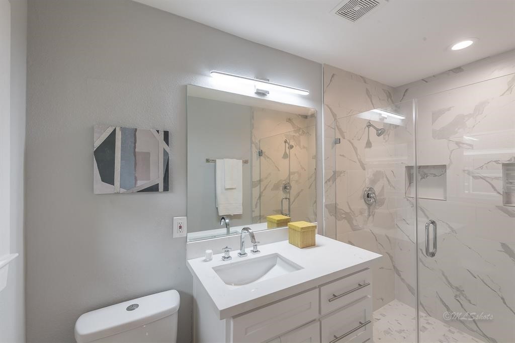 10058 Larston Street Houston, TX 77055 - Photo 14 of 18 a bathroom with a sink vanity granite and a mirror