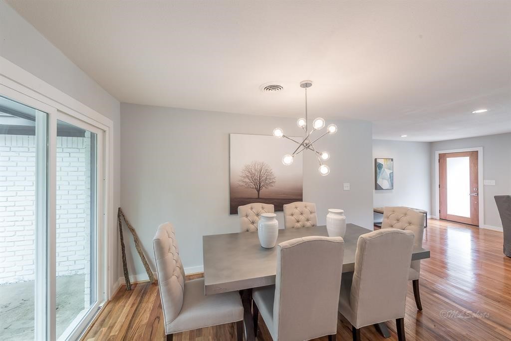 10058 Larston Street Houston, TX 77055 - Photo 8 of 18 a view of a dining room with furniture and wooden floor