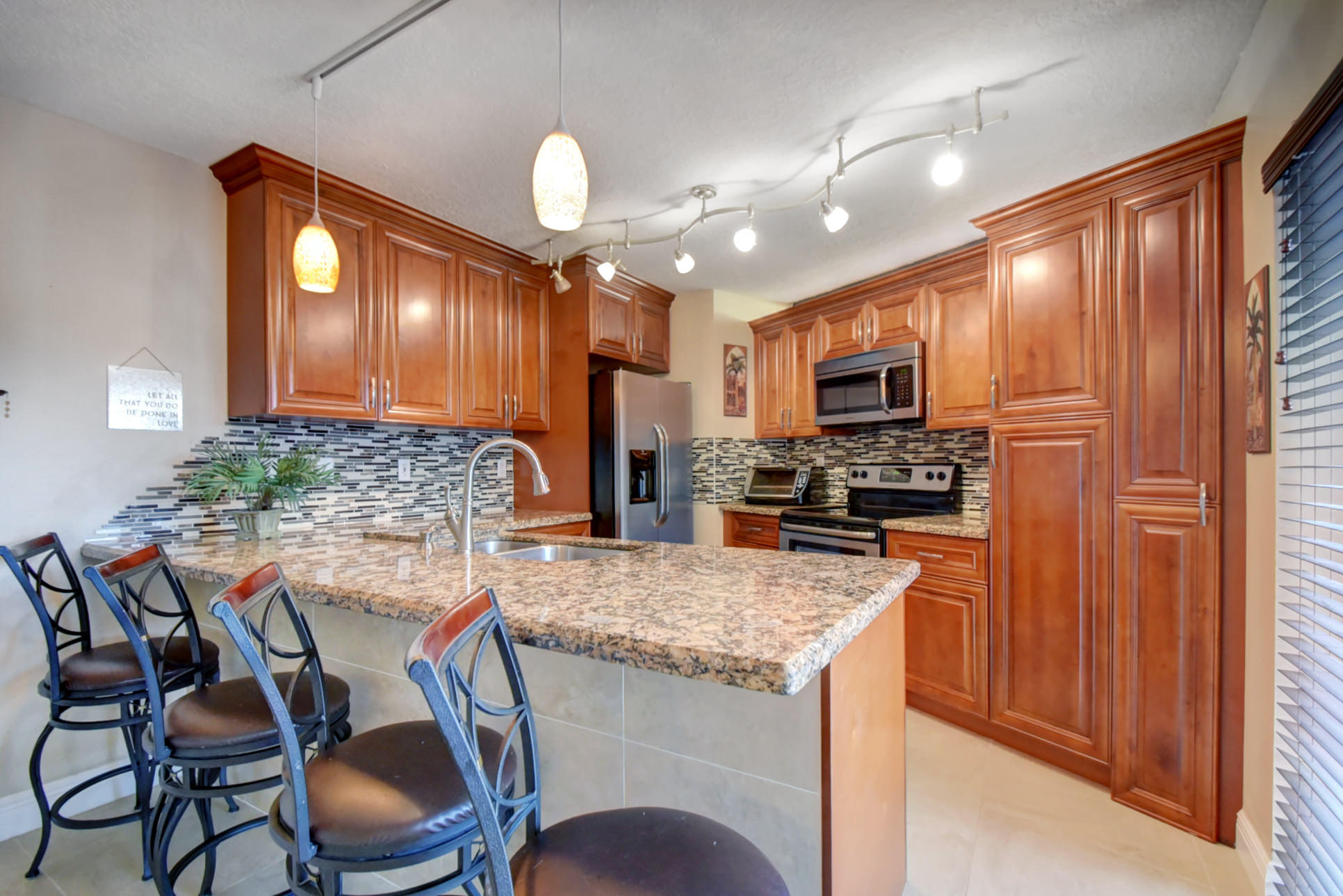 a kitchen with cabinets and chairs