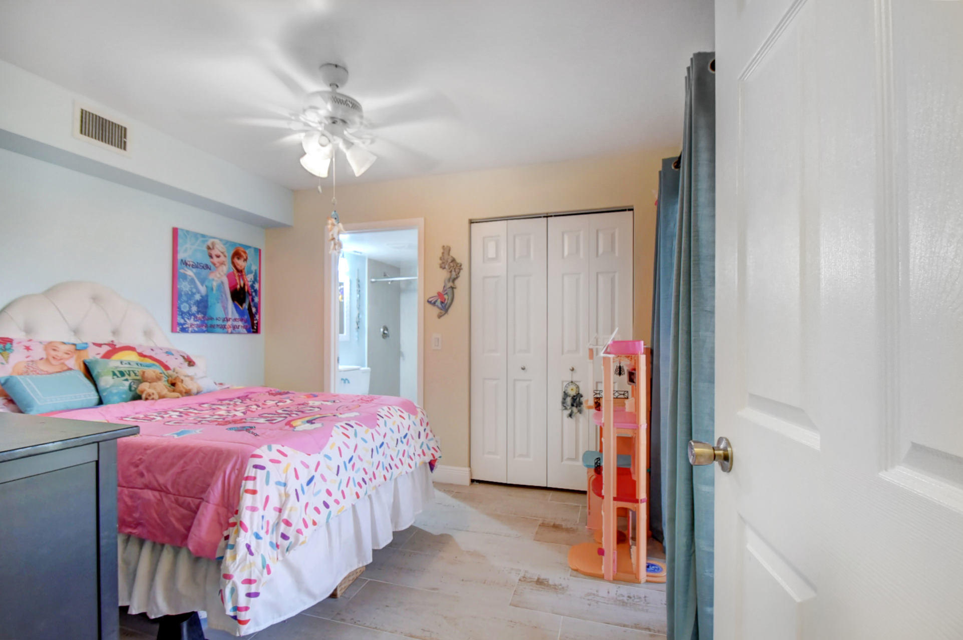 23048 Oxford Place, Unit A Boca Raton, FL 33433 - Photo 13 of 18 a bedroom with a bed and a chandelier
