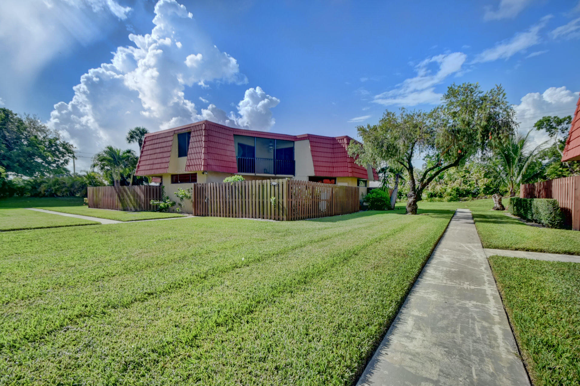 23048 Oxford Place, Unit A Boca Raton, FL 33433 - Photo 2 of 18 a front view of a house with a yard