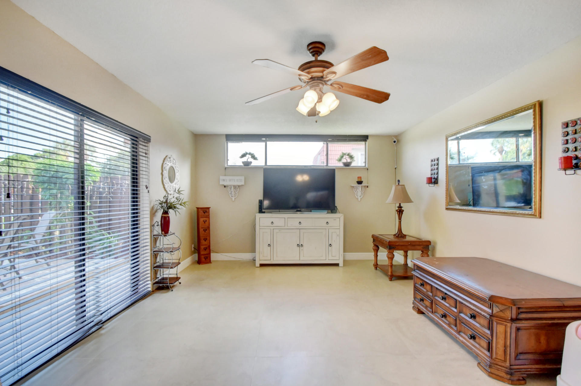 23048 Oxford Place, Unit A Boca Raton, FL 33433 - Photo 3 of 18 a living room with furniture and a chandelier