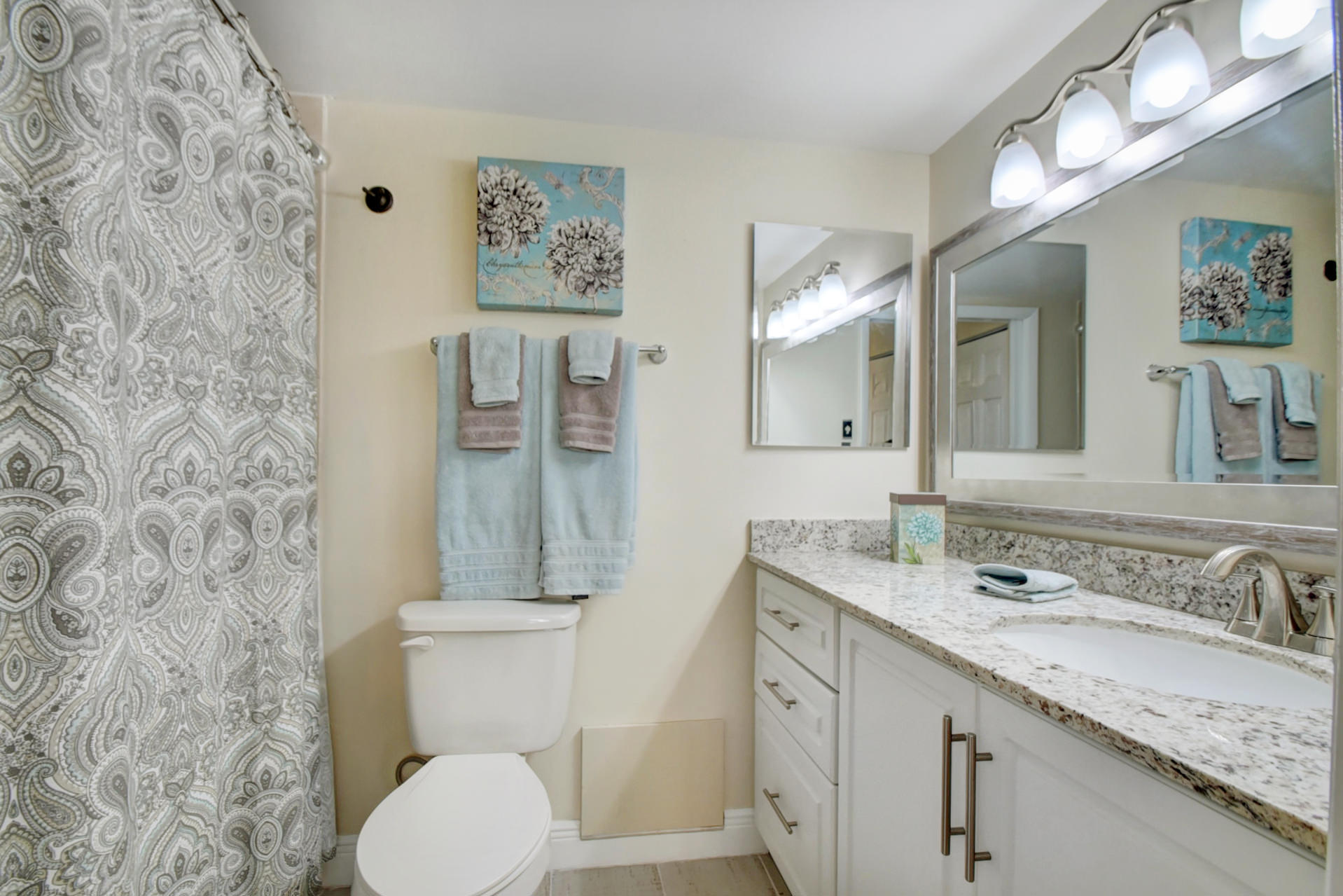23048 Oxford Place, Unit A Boca Raton, FL 33433 - Photo 4 of 18 a bathroom with a granite countertop toilet sink and mirror