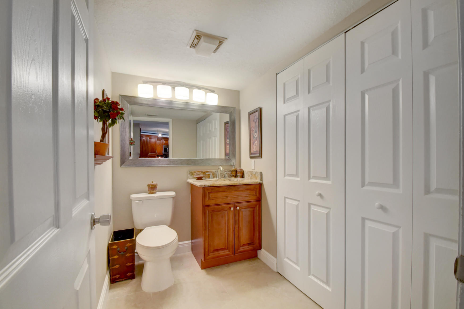 23048 Oxford Place, Unit A Boca Raton, FL 33433 - Photo 8 of 18 a bathroom with a toilet sink shower and mirror