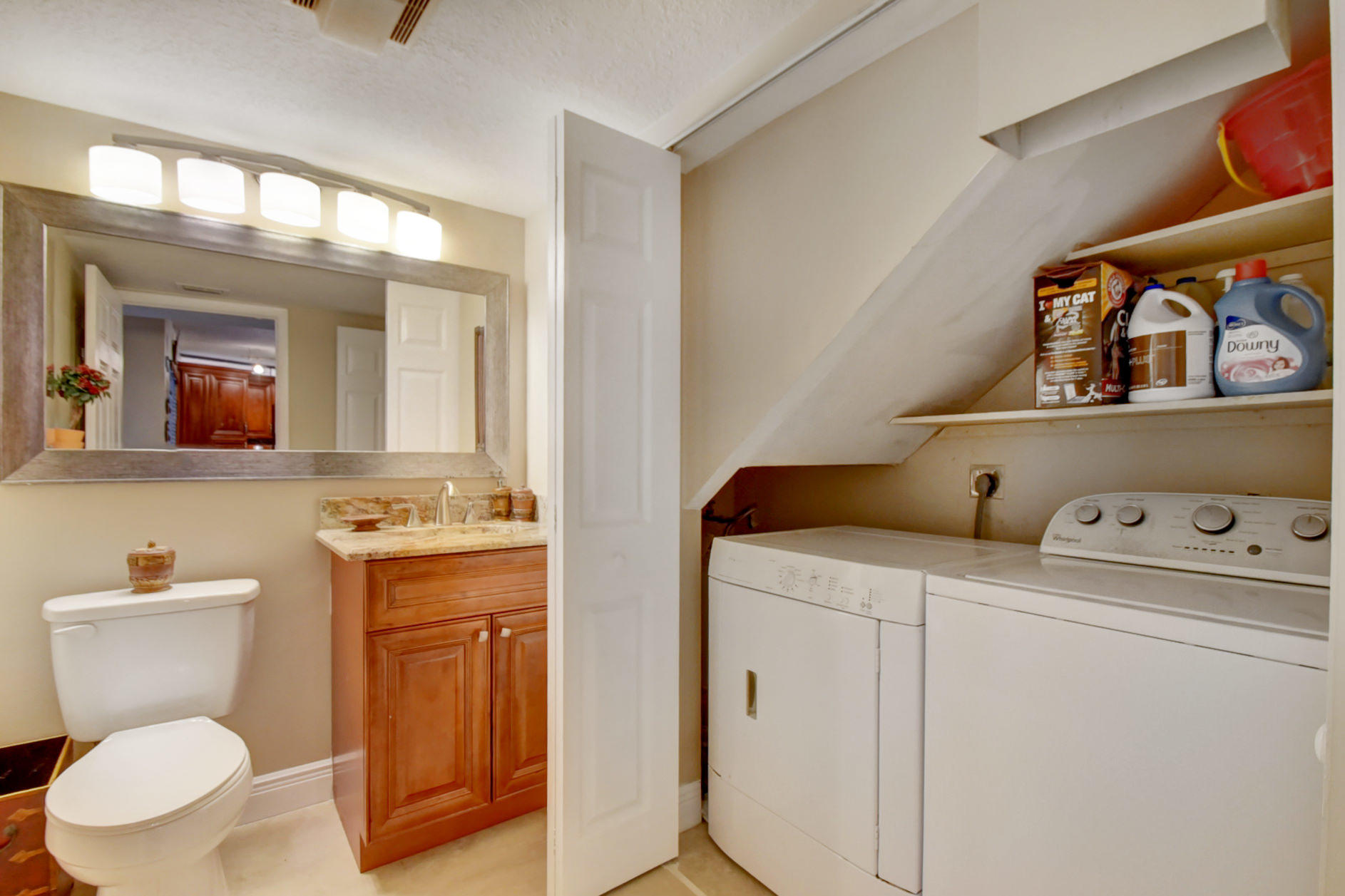 23048 Oxford Place, Unit A Boca Raton, FL 33433 - Photo 9 of 18 a bathroom with a toilet sink and mirror