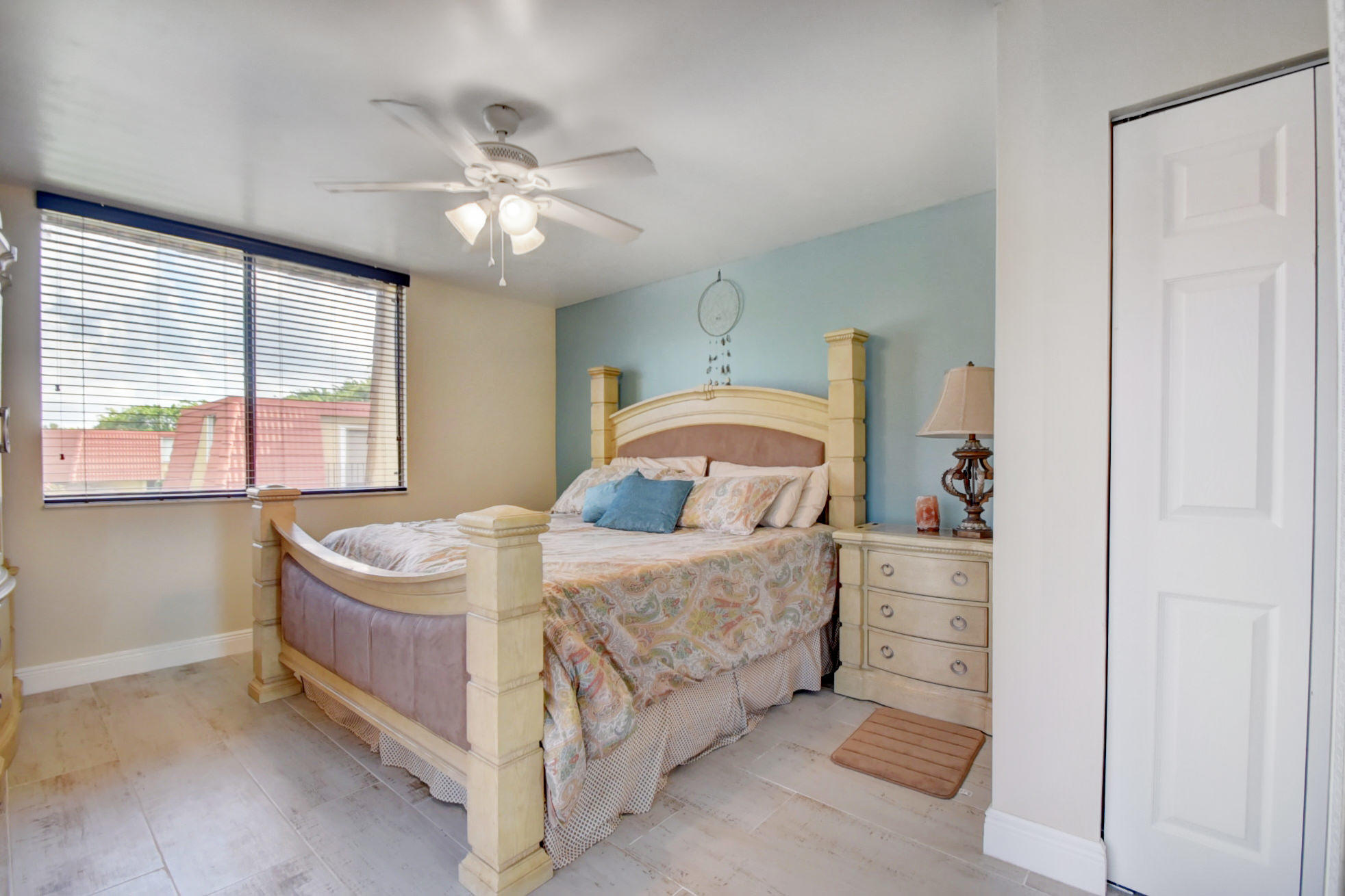 23048 Oxford Place, Unit A Boca Raton, FL 33433 - Photo 10 of 18 a bedroom with a bed and a chandelier