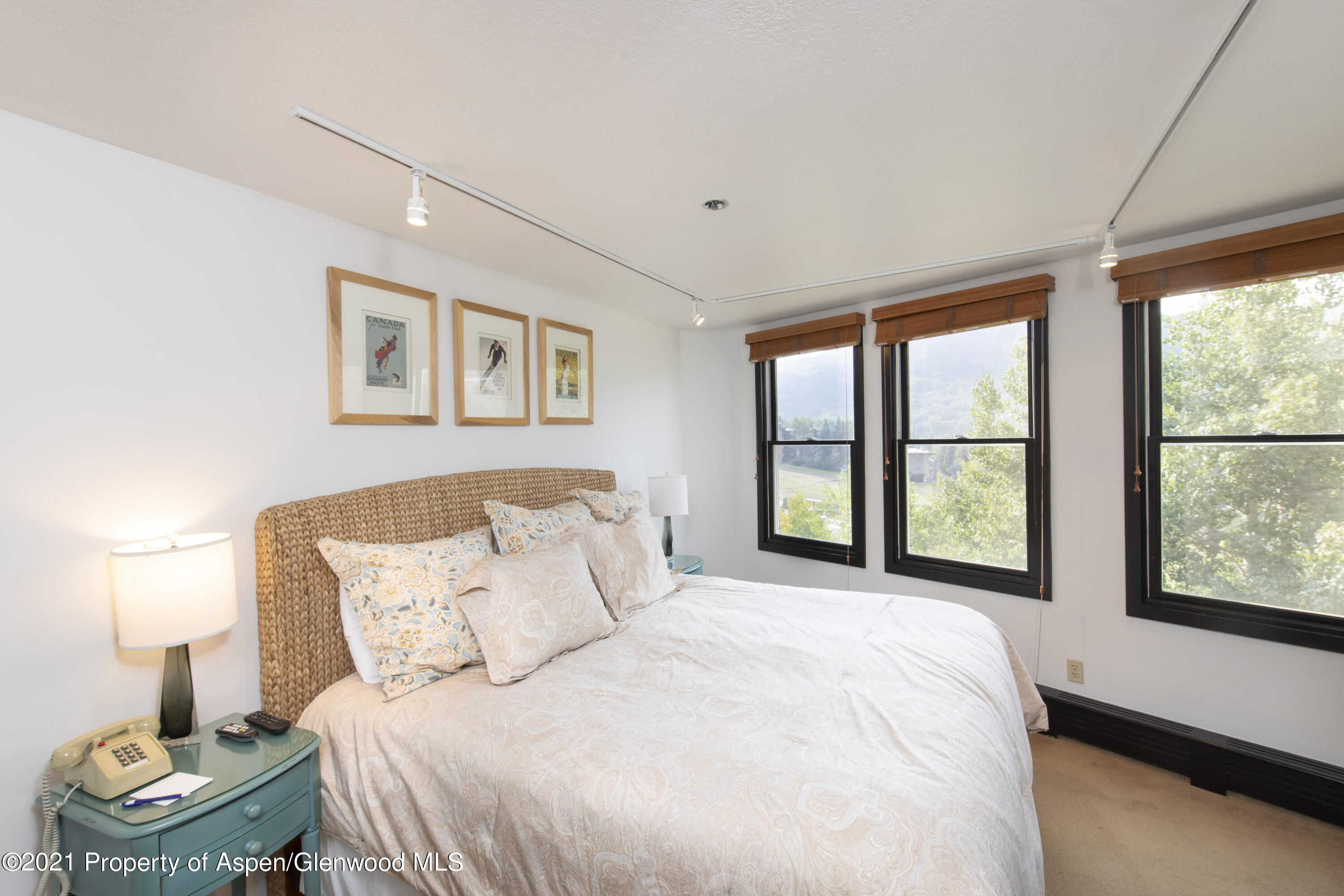 425 Wood Run Road, Unit 36 Snowmass Village, CO 81615 - Photo 11 of 23 a bedroom with a bed and a large window