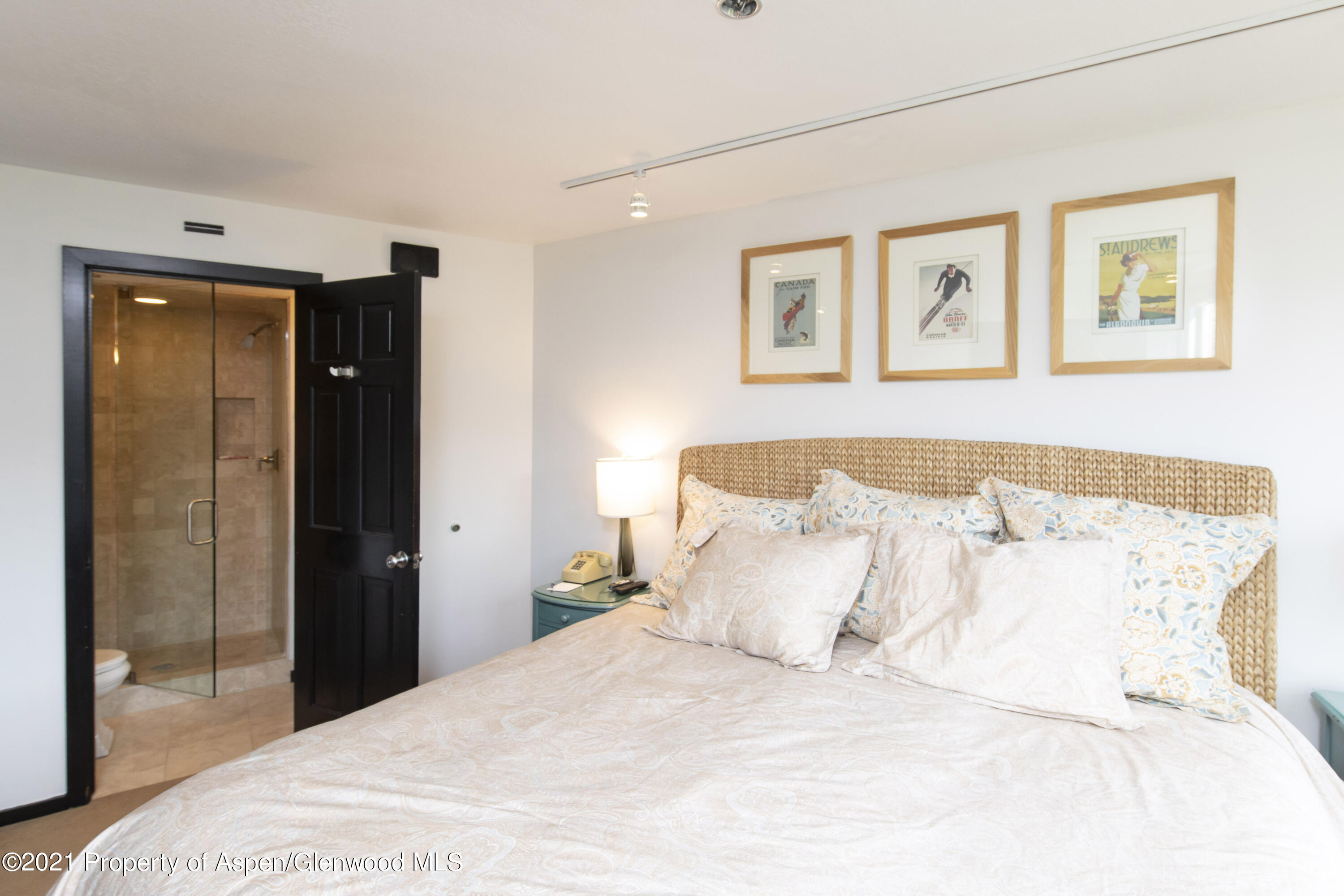 425 Wood Run Road, Unit 36 Snowmass Village, CO 81615 - Photo 12 of 23 a bedroom with a bed and a painting on the wall