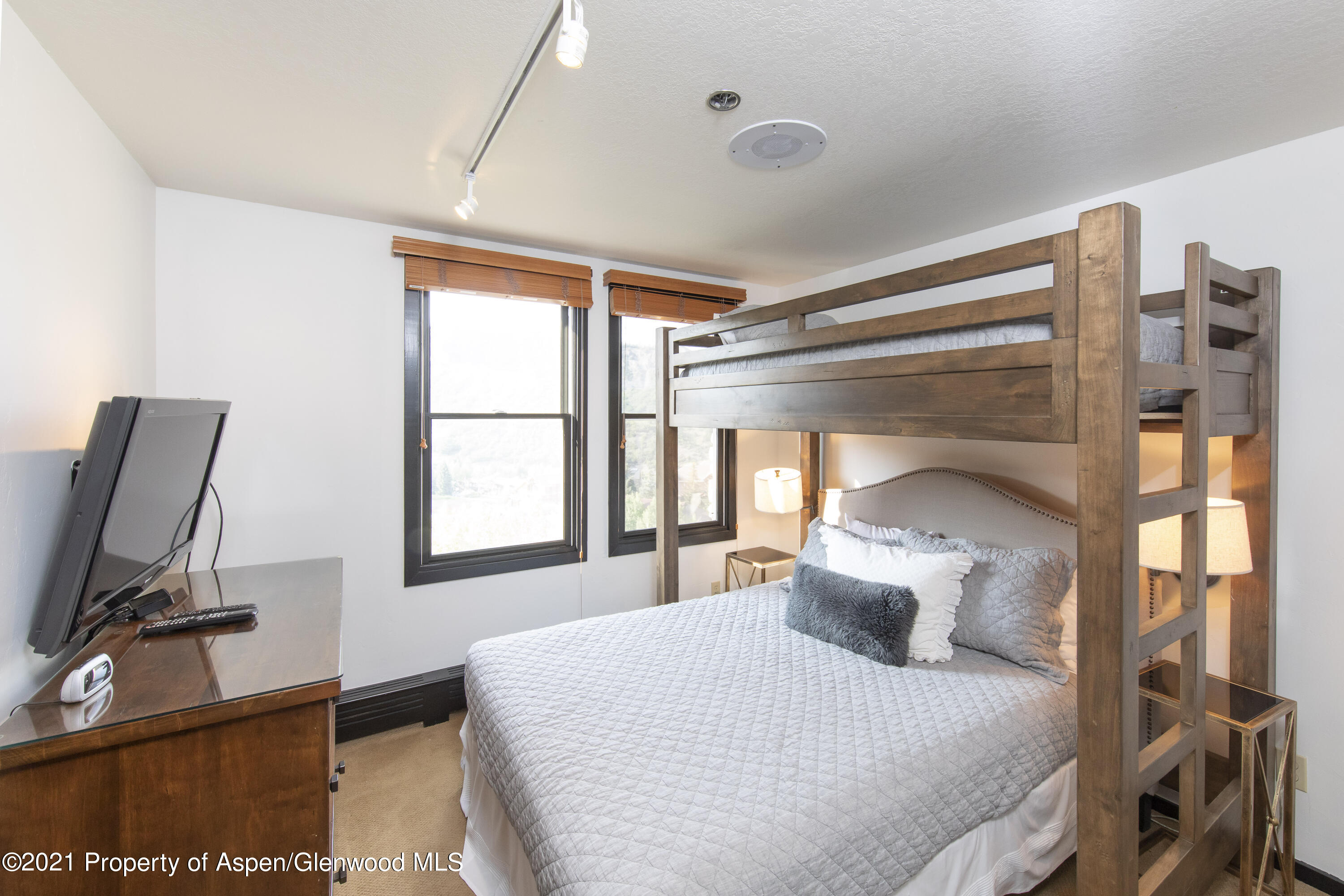 425 Wood Run Road, Unit 36 Snowmass Village, CO 81615 - Photo 14 of 23 a bedroom with a bed window and mirror