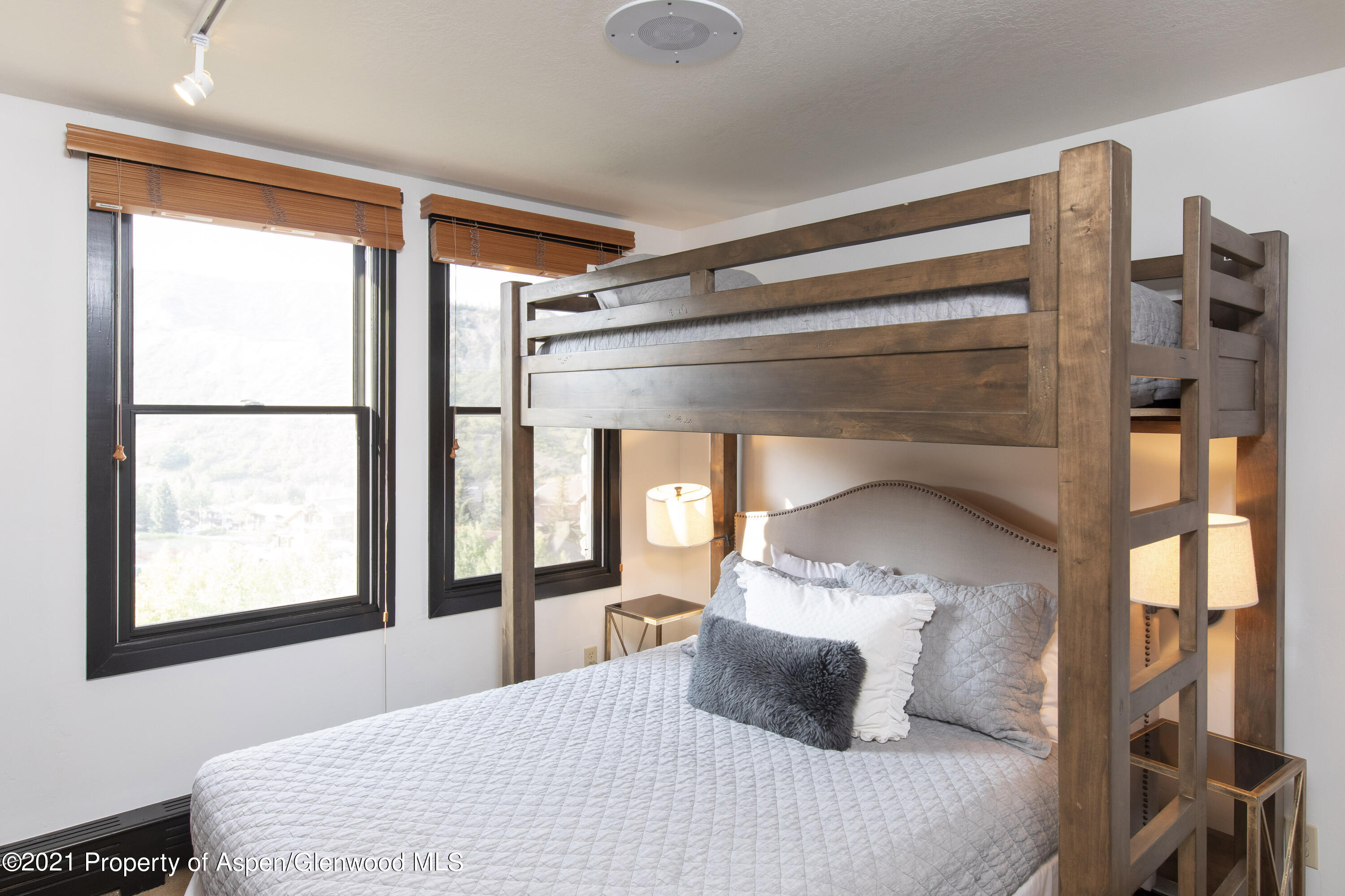 425 Wood Run Road, Unit 36 Snowmass Village, CO 81615 - Photo 15 of 23 a bedroom with a large bed and a large window