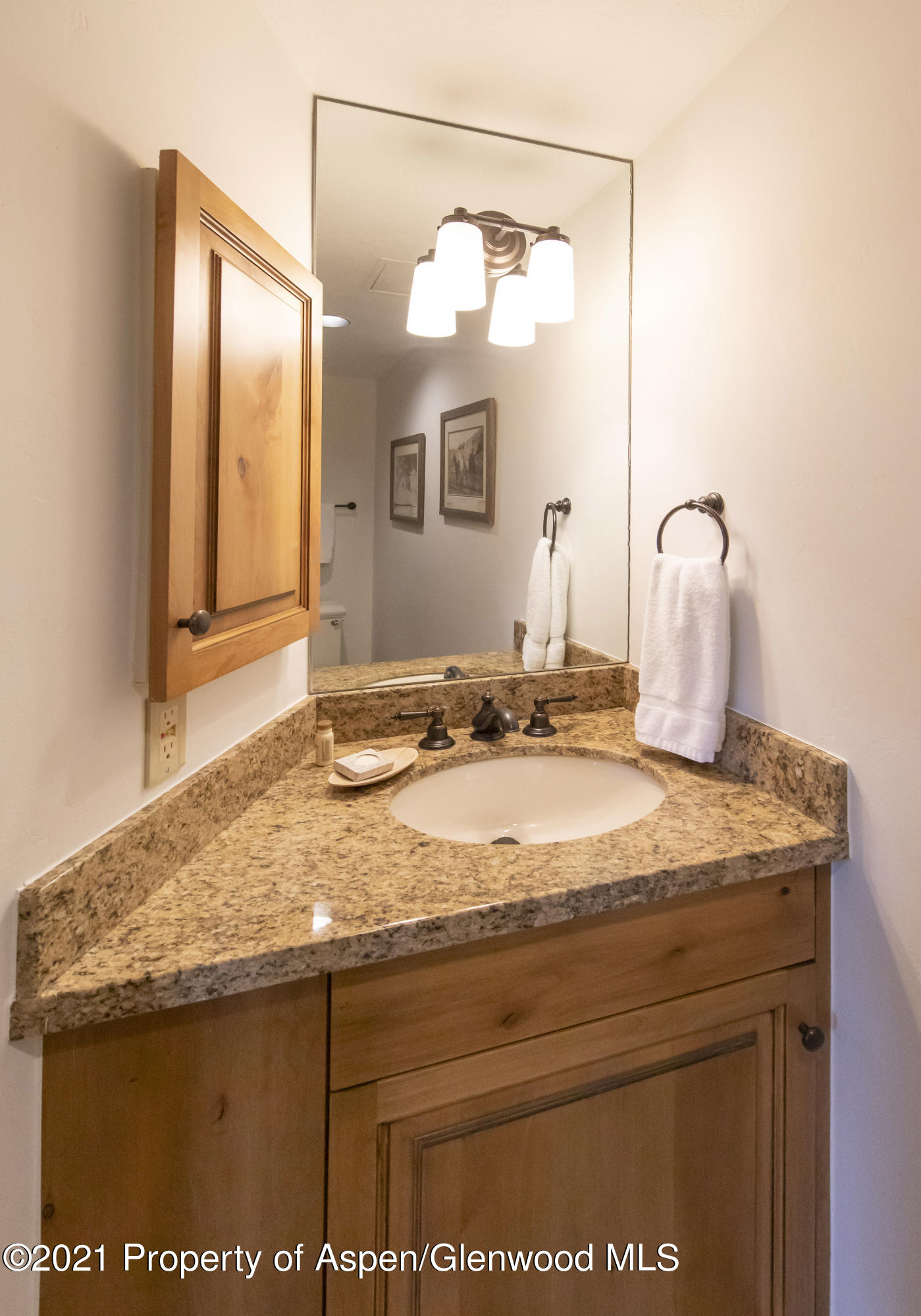425 Wood Run Road, Unit 36 Snowmass Village, CO 81615 - Photo 17 of 23 a bathroom with a granite countertop sink and a mirror