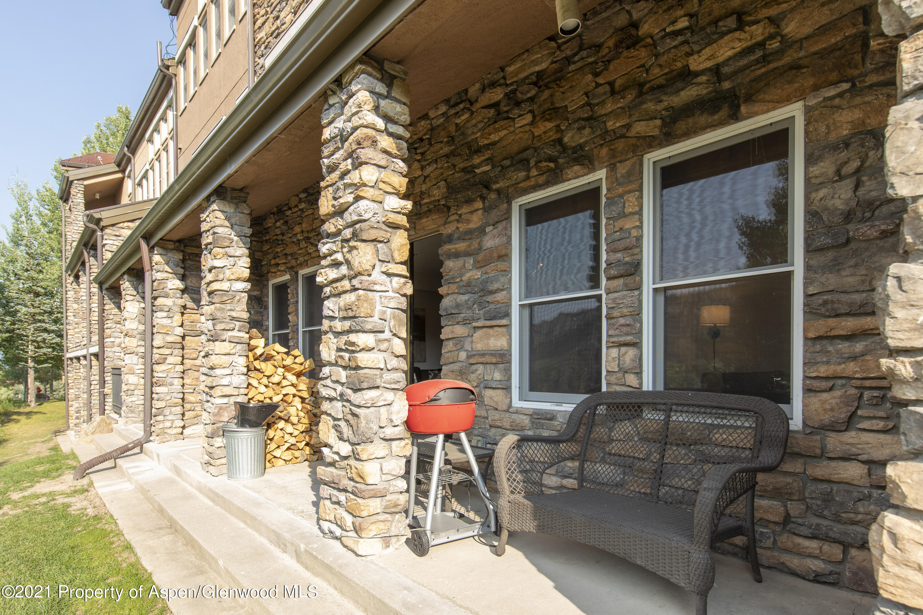 425 Wood Run Road, Unit 36 Snowmass Village, CO 81615 - Photo 18 of 23 a patio with table and chairs and potted plants