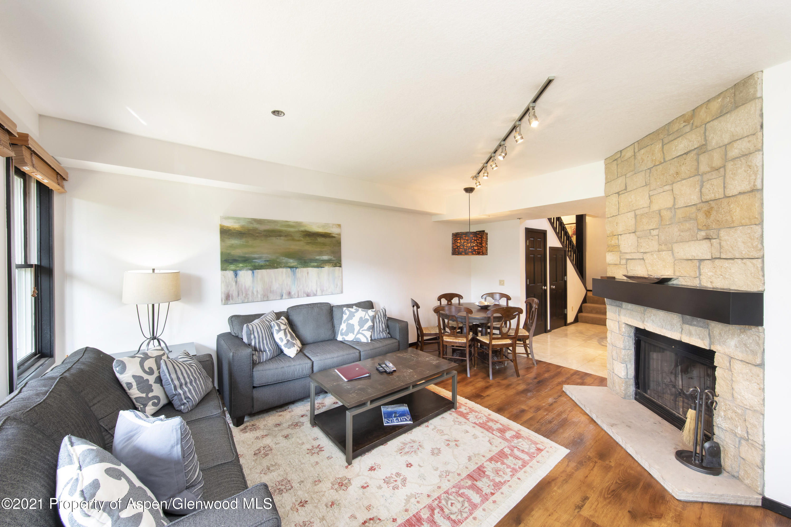 425 Wood Run Road, Unit 36 Snowmass Village, CO 81615 - Photo 4 of 23 a living room with furniture a fireplace and a large window