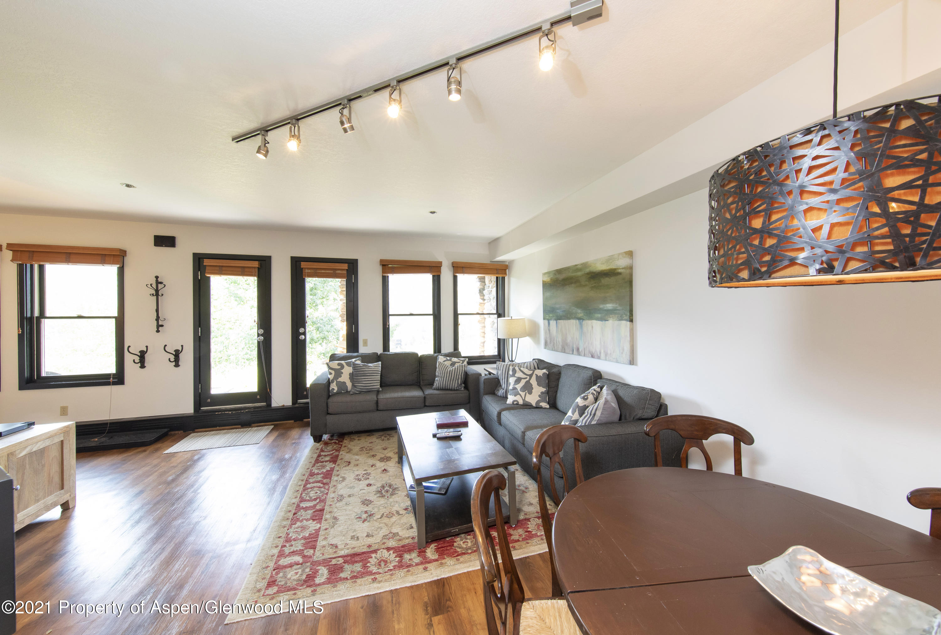425 Wood Run Road, Unit 36 Snowmass Village, CO 81615 - Photo 5 of 23 a living room with furniture and wooden floor