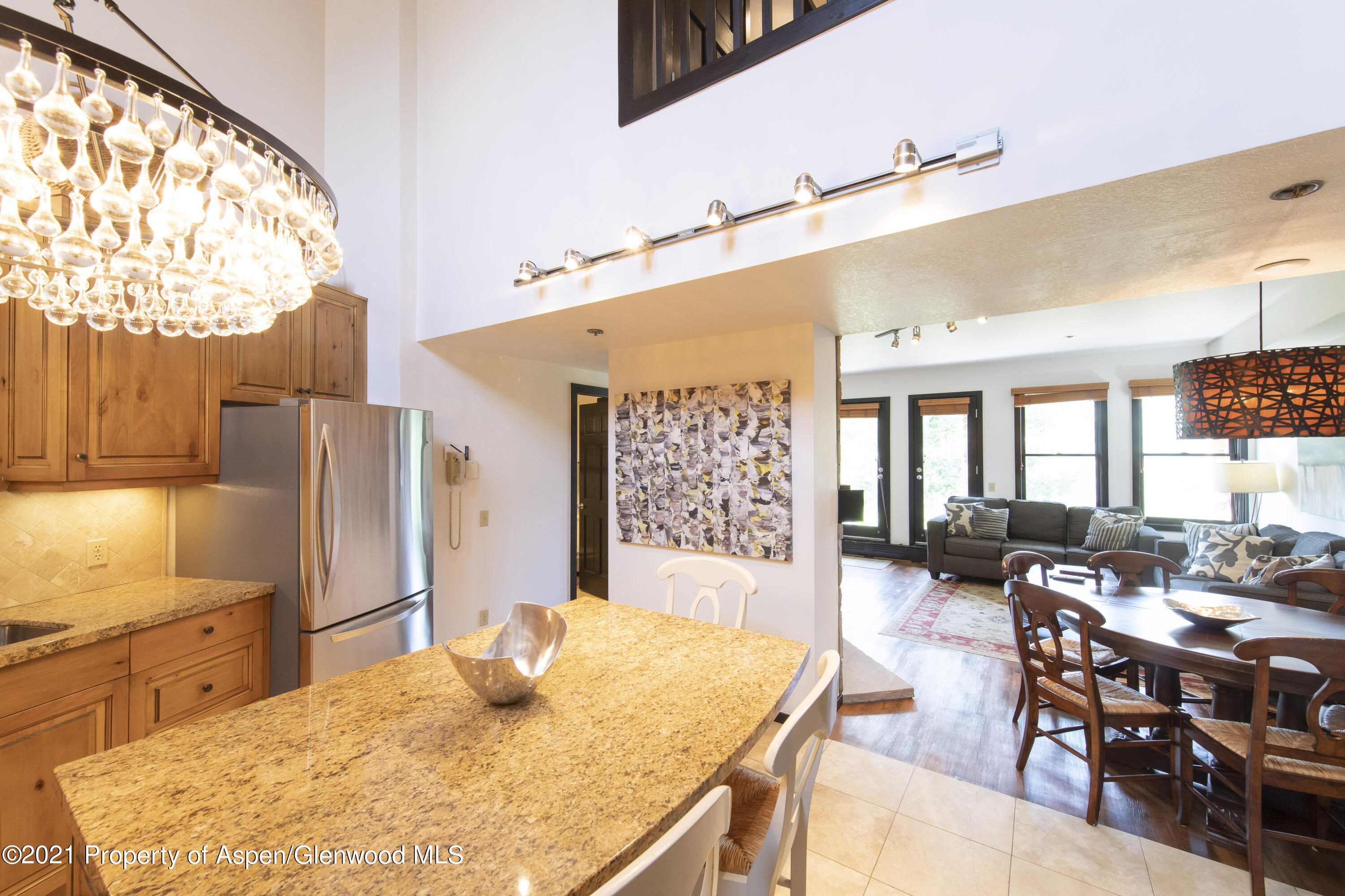 425 Wood Run Road, Unit 36 Snowmass Village, CO 81615 - Photo 8 of 23 a living room with stainless steel appliances kitchen island granite countertop furniture and a large window