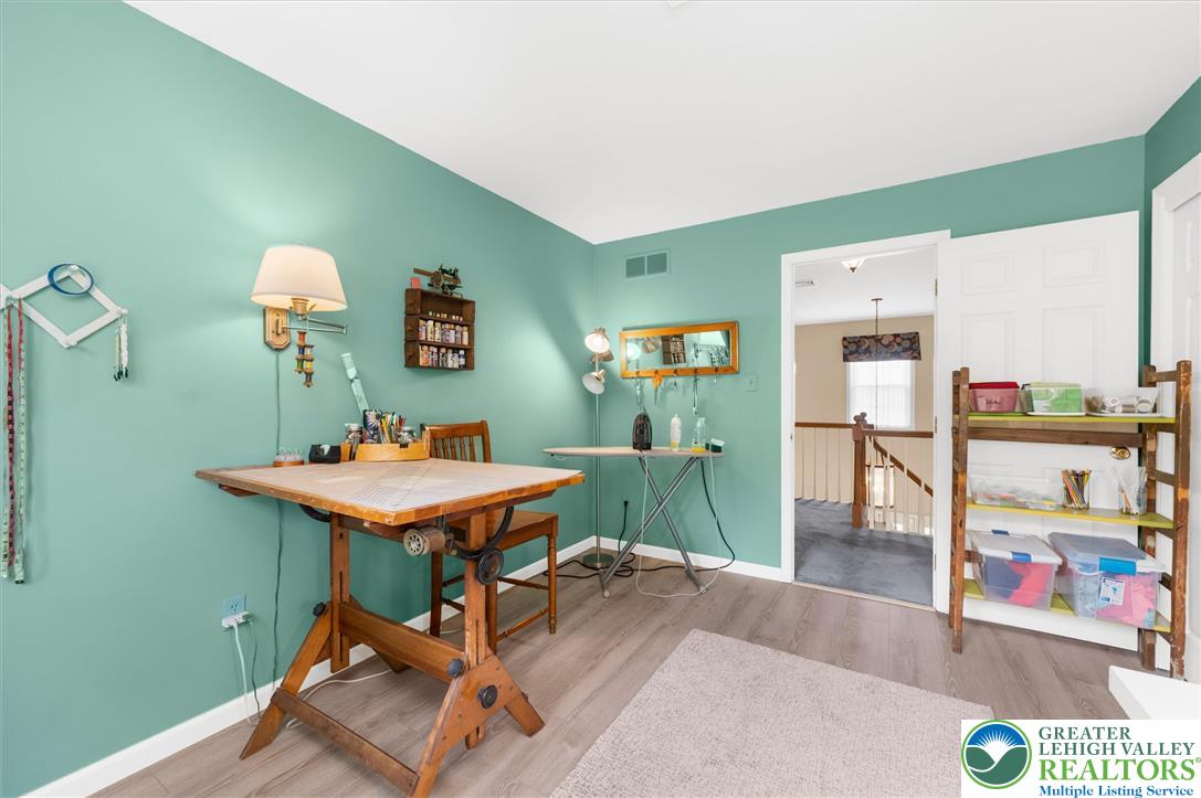 5616 Snowdrift Road Orefield, PA 18069 - Photo 20 of 36 A versatile hobby room with light wood-tone flooring and ample natural illumination for creative pursuits.